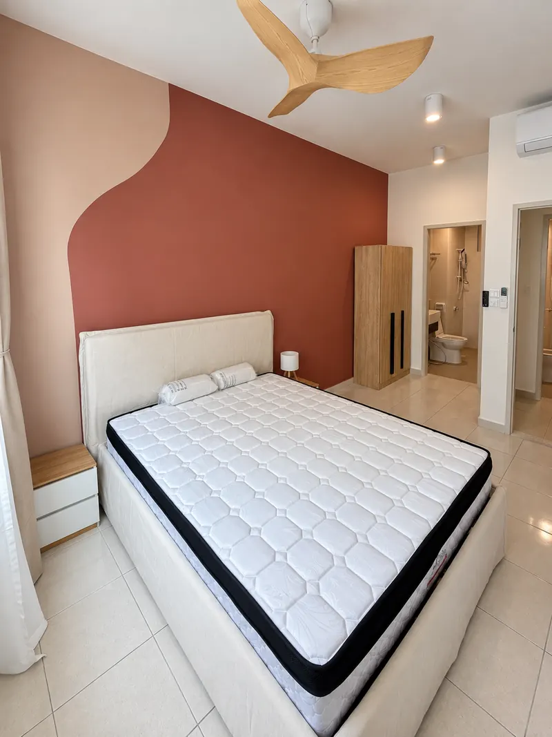 Bedroom with bed, wardrobe and ensuite doorway.